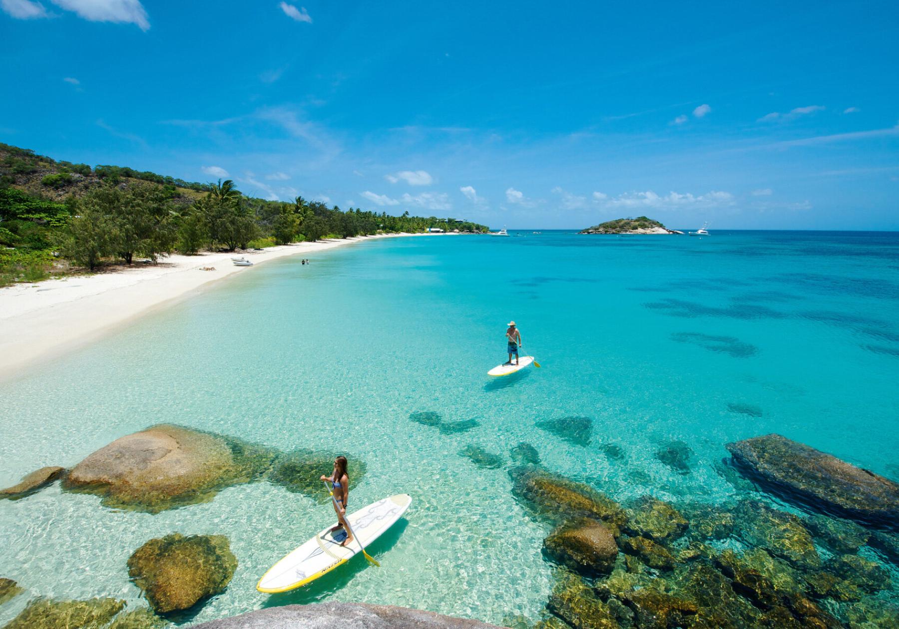 paddle boarding over crytal clear waters