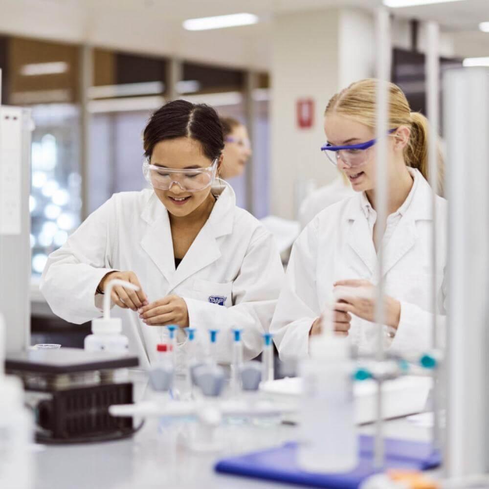 two young women in lab coats